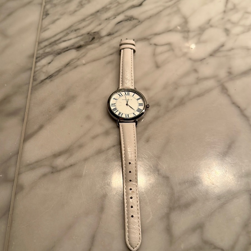 Anne Klein watch - w/white leather strap. Round dial Roman numerals.  2nd hand